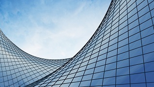 A skyscraper covered in glass.