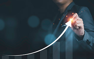 Businessman showing increasing growth with an arrow on a graph